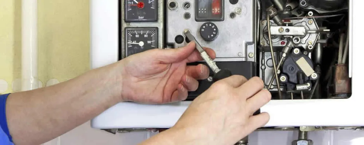 Heating repair technician adjusting boiler controls and components in Albuquerque, NM